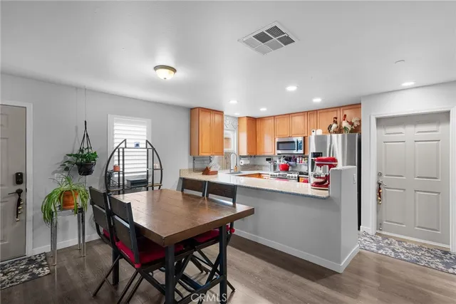 a kitchen with stainless steel appliances kitchen island granite countertop a sink and cabinets