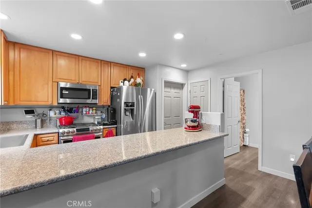 a kitchen view with microwave a stove and cabinets