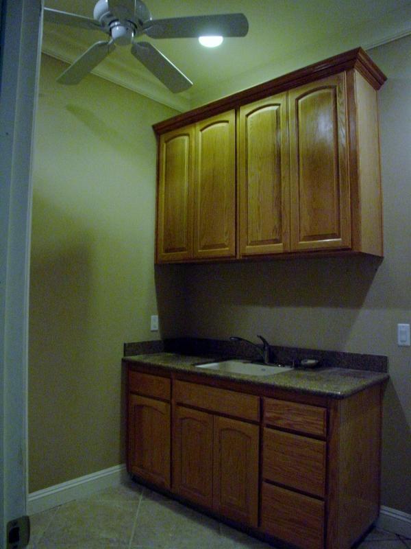 2416 Rodeo Street Selma, CA 93662 - Photo 86 of 99 Laundry room with washboard sink and cabinets
