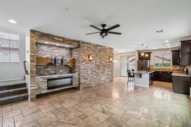 a kitchen with stainless steel appliances kitchen island granite countertop a sink and cabinets