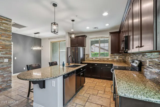 a kitchen with sink and chandelier