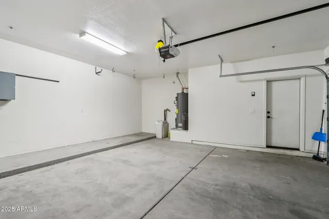 an empty room with windows and ceiling fan view