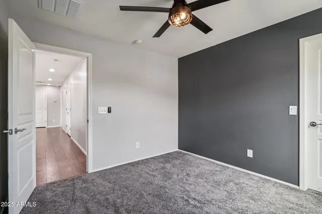 a view of a big room with closet and mirror