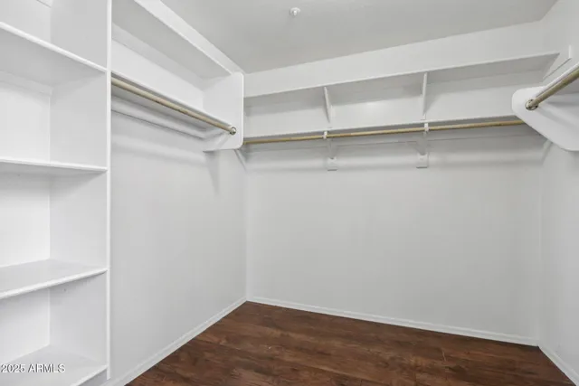 a view of a livingroom with a ceiling fan & entryway