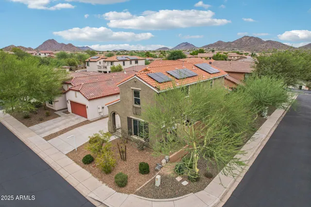 an aerial view of residential houses with outdoor space and trees