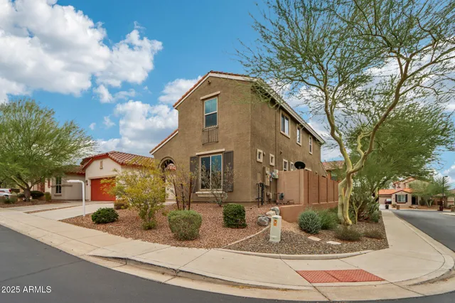 a front view of a house with street and trees