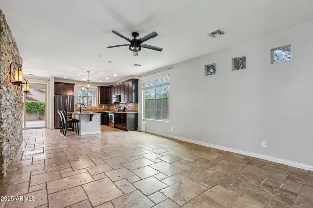 a living room with stainless steel appliances kitchen island granite countertop furniture and a fireplace