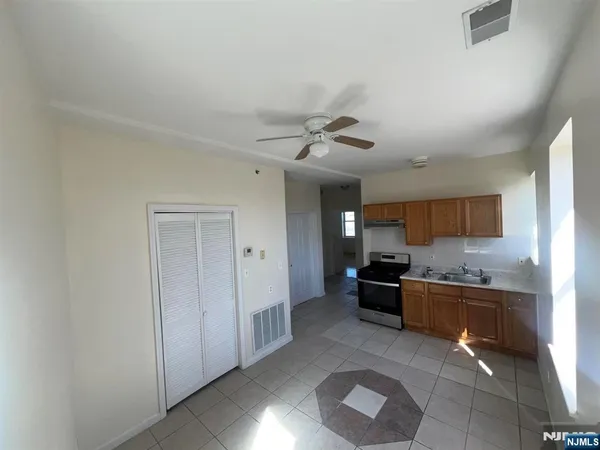 a kitchen with a stove a refrigerator and a sink