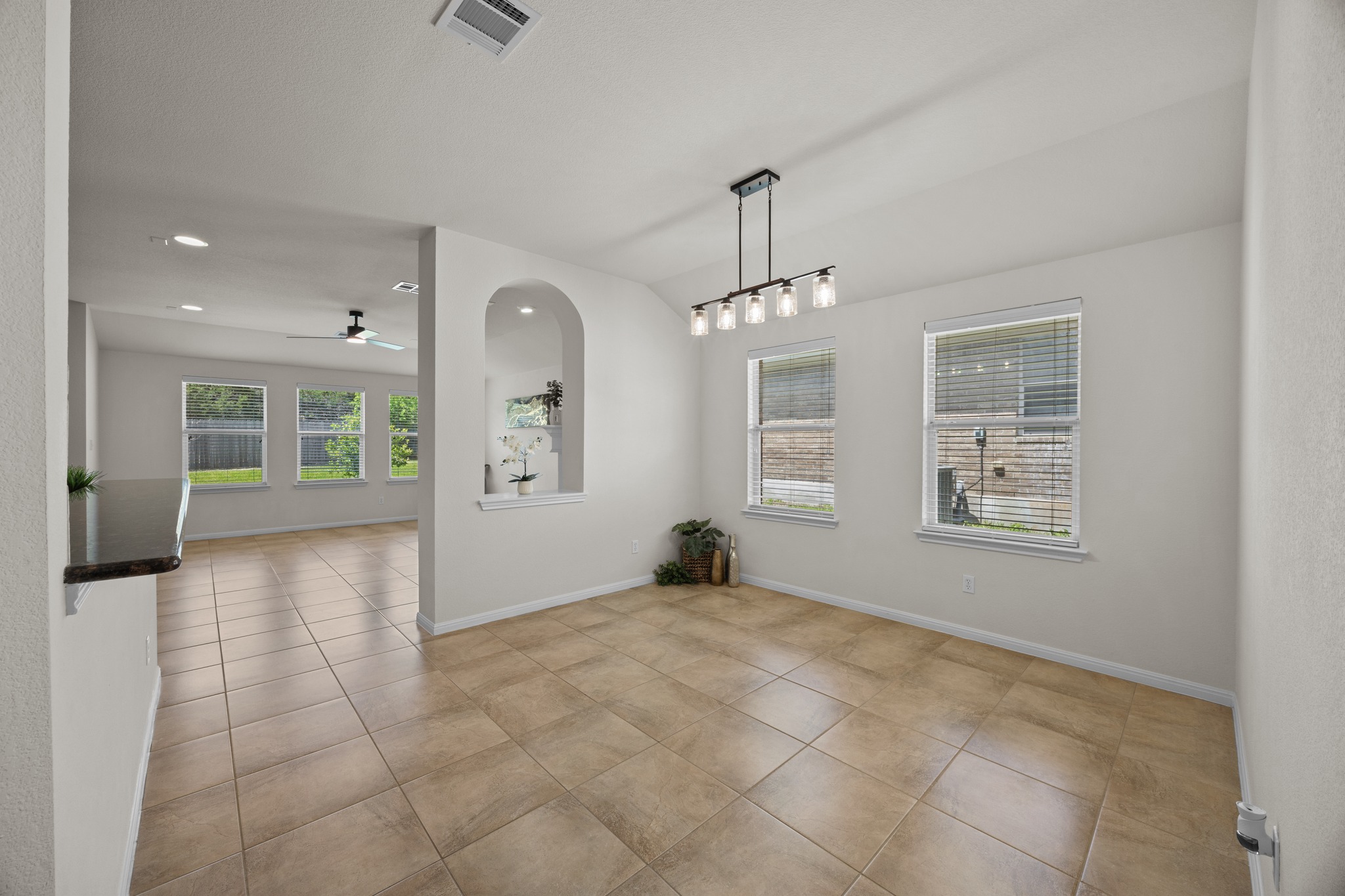 1317 Rimstone Drive Cedar Park, TX 78613 - Photo 10 of 32 Unfurnished dining area with light tile patterned floors, ceiling fan, lofted ceiling, and recessed lighting