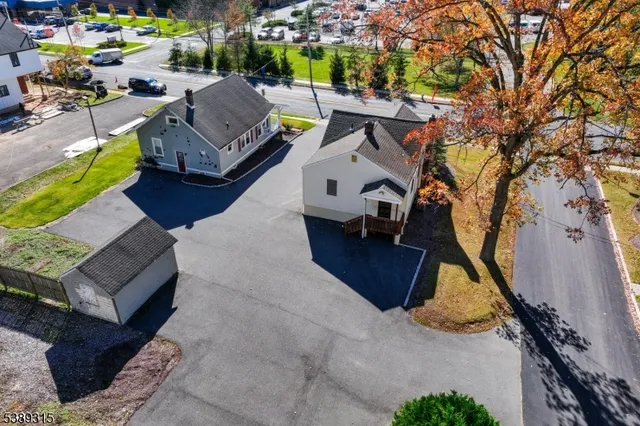 an aerial view of a houses with a lake view