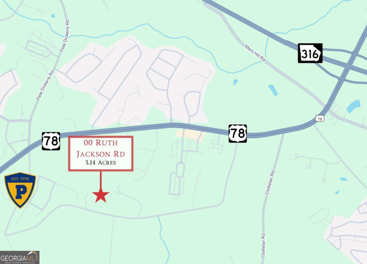 a street sign on a wall next to a road