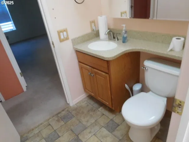 a bathroom with a toilet sink and mirror