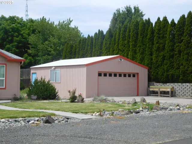 a front view of house with a garden