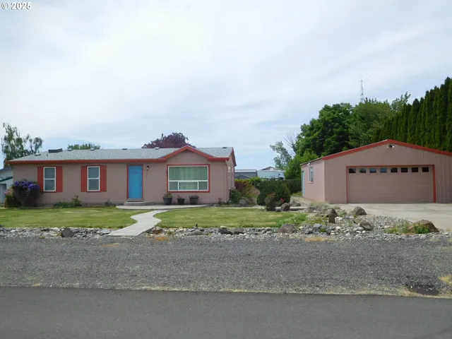 a large house with a big yard and large trees