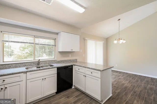 a kitchen with a sink window and cabinets