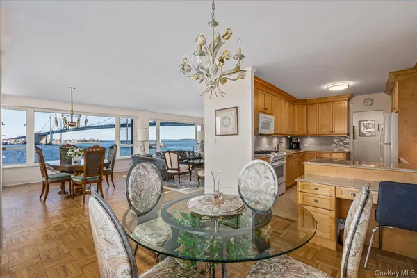 a view of a dining room with furniture a chandelier and wooden floor