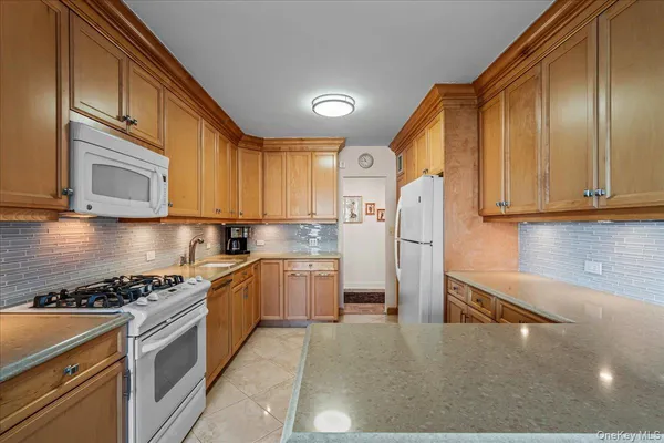 a kitchen with stainless steel appliances granite countertop a stove refrigerator sink and cabinets