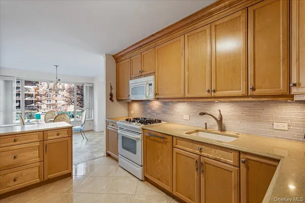 a kitchen with stainless steel appliances granite countertop a sink and cabinets with wooden floor