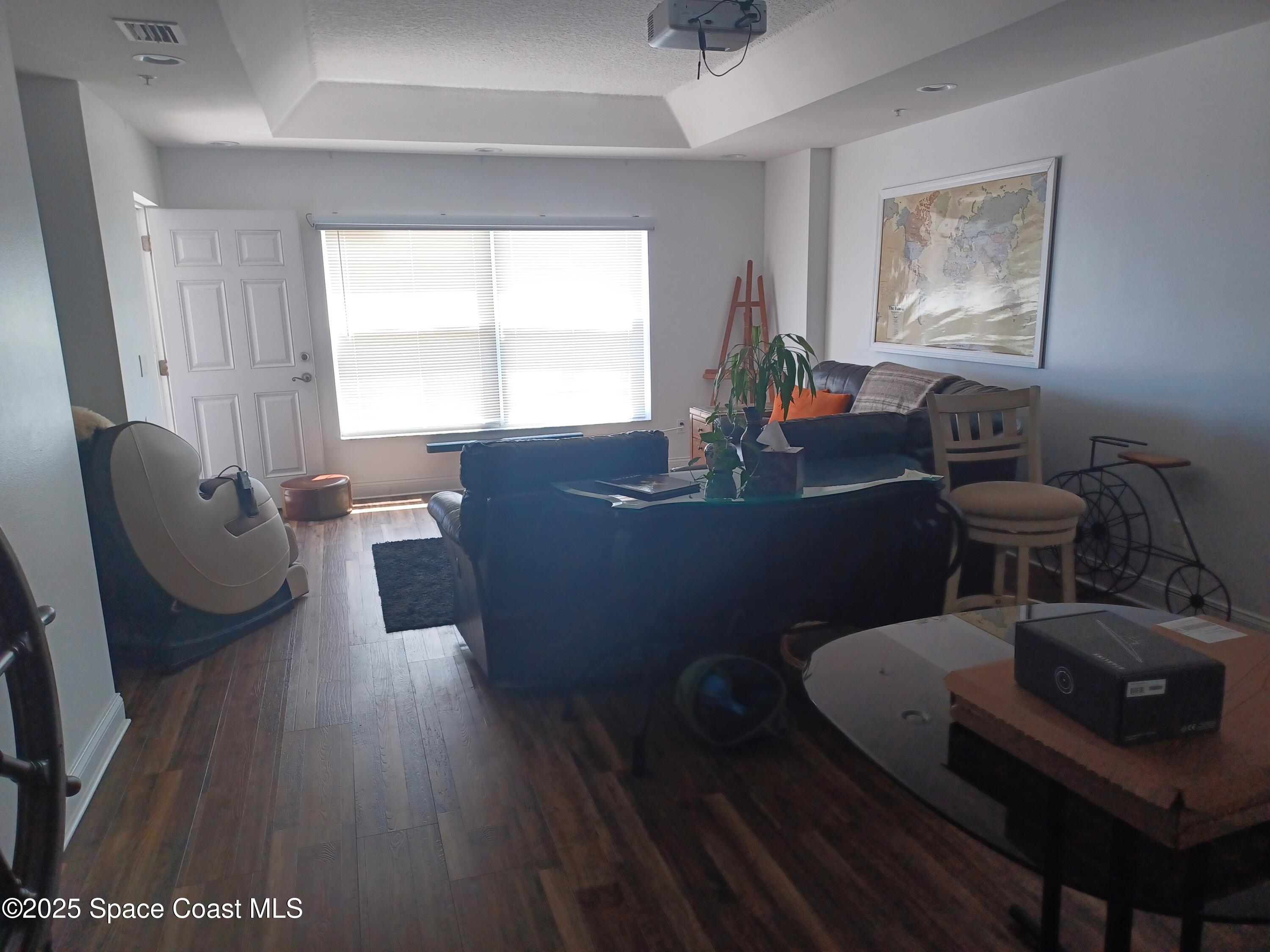 105 Pulsipher Avenue, Unit 403 Cocoa Beach, FL 32931 - Photo 12 of 15 a living room with furniture and a window