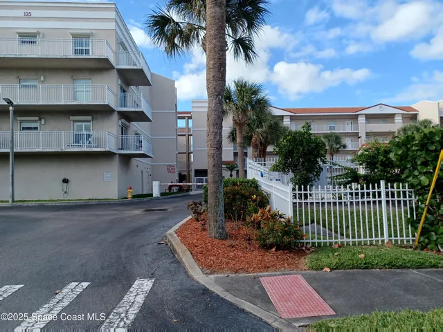 a view of a house with a yard and plants