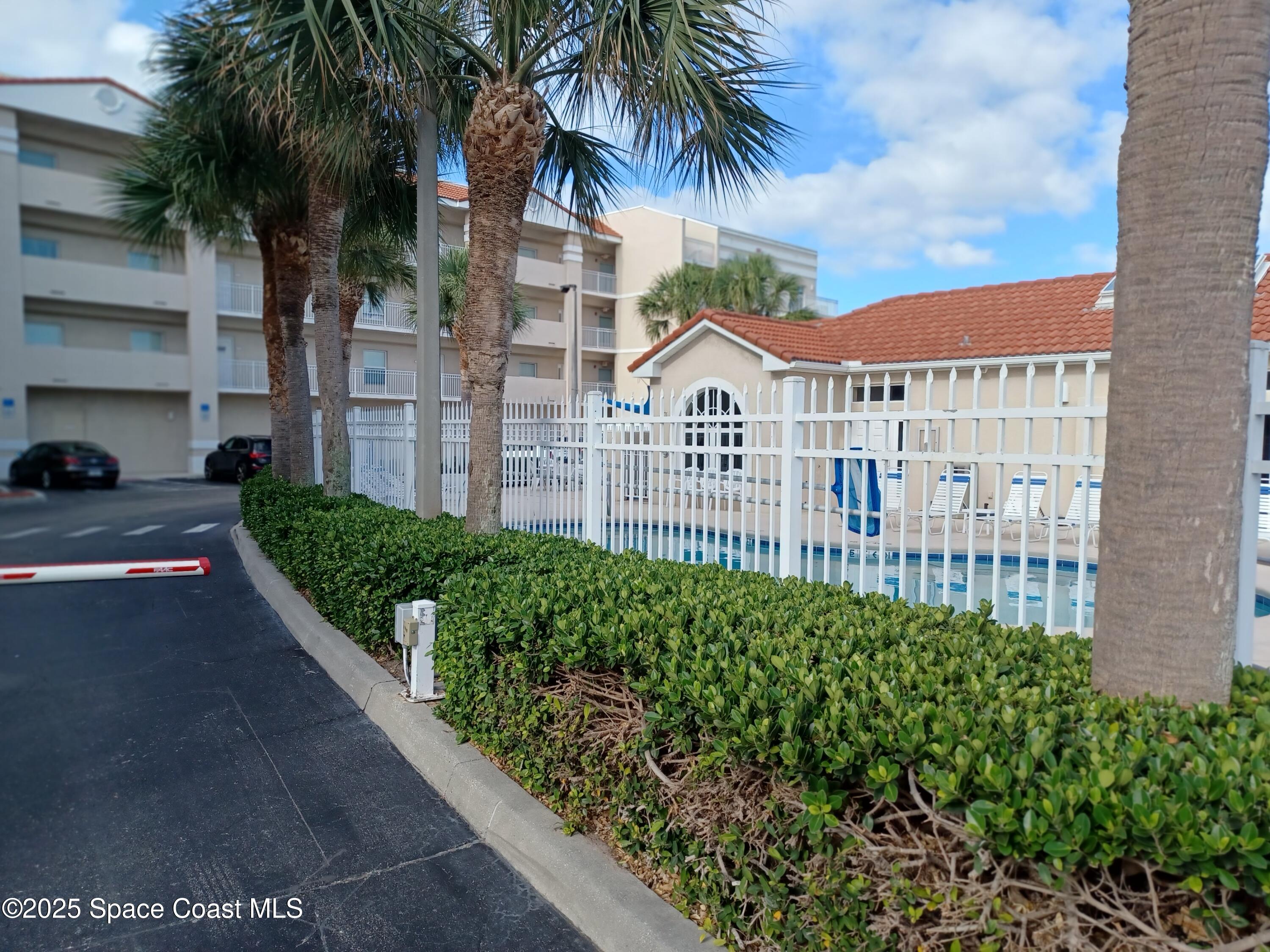 105 Pulsipher Avenue, Unit 403 Cocoa Beach, FL 32931 - Photo 15 of 15 a view of a garden with a street