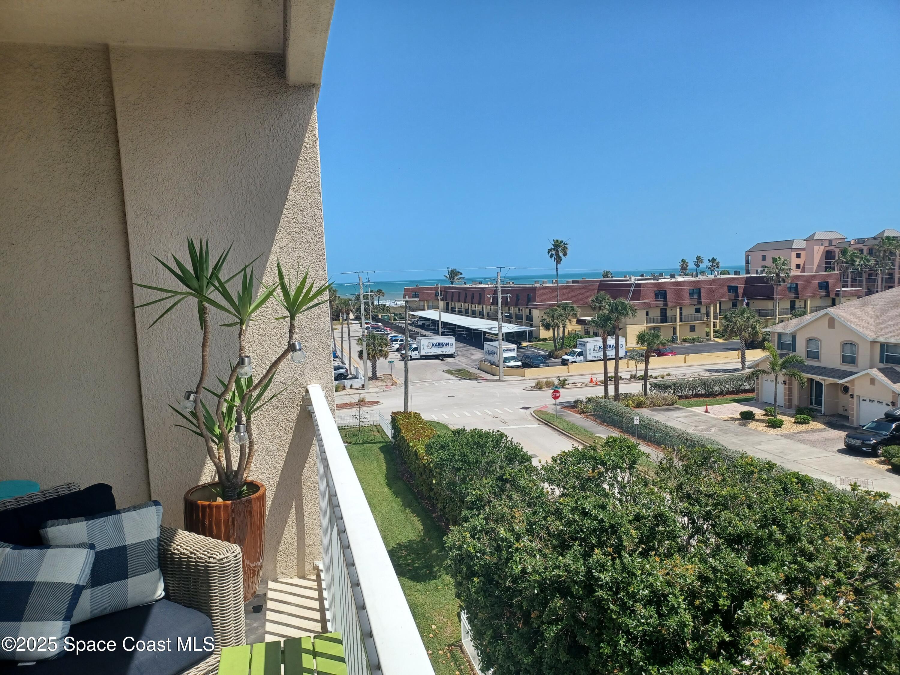 105 Pulsipher Avenue, Unit 403 Cocoa Beach, FL 32931 - Photo 2 of 15 a view of a swimming pool with a patio and a yard