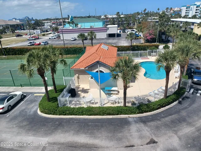 a view of a house with a yard and potted plants