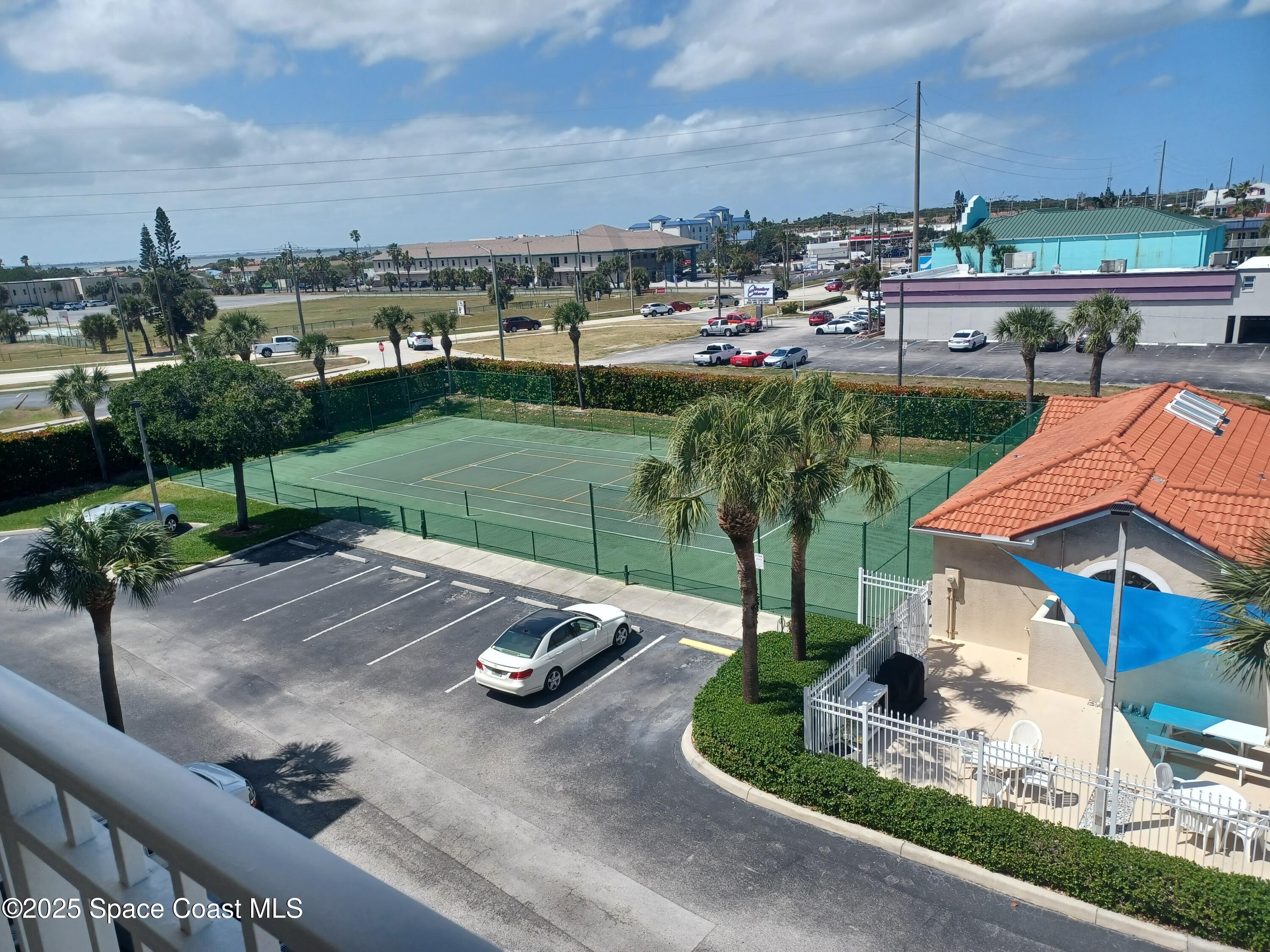 105 Pulsipher Avenue, Unit 403 Cocoa Beach, FL 32931 - Photo 4 of 15 a view of a backyard with sitting area