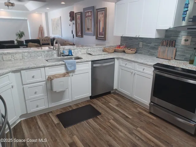 a kitchen with a sink stove and cabinets