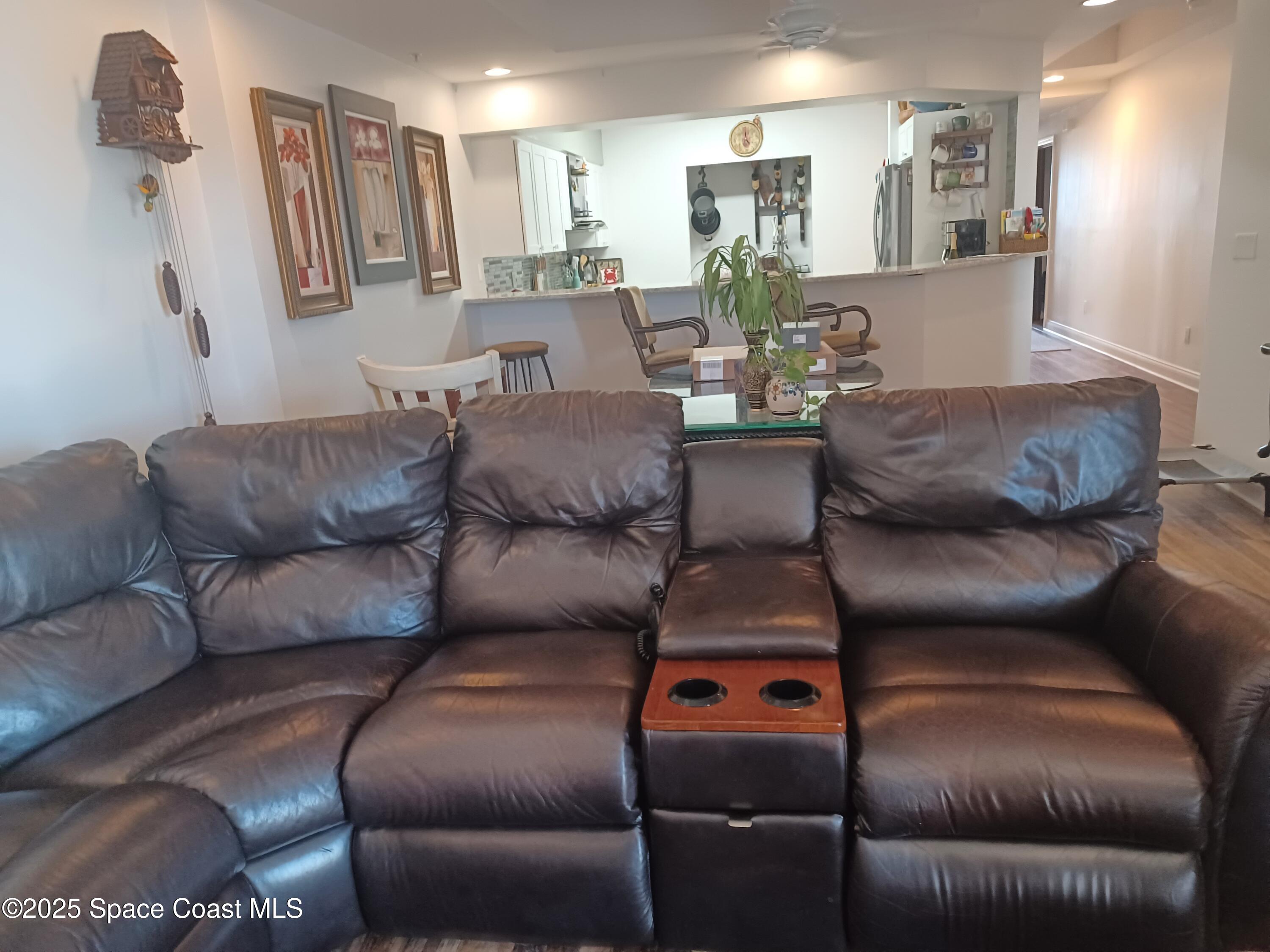 105 Pulsipher Avenue, Unit 403 Cocoa Beach, FL 32931 - Photo 9 of 15 a living room with furniture and a couch