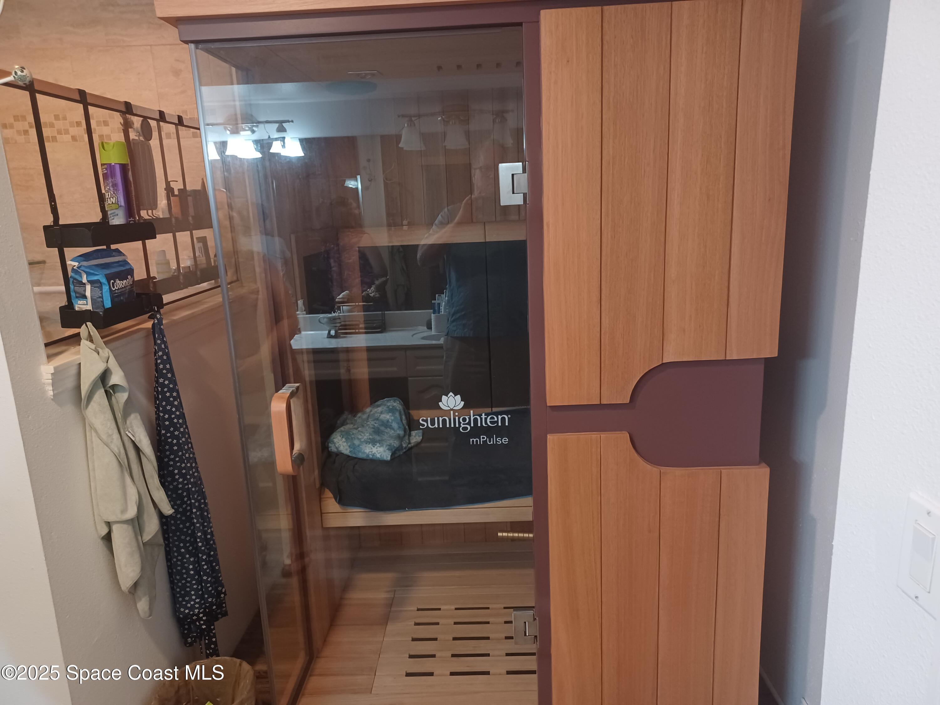 105 Pulsipher Avenue, Unit 403 Cocoa Beach, FL 32931 - Photo 10 of 15 a bathroom with a sink and a mirror