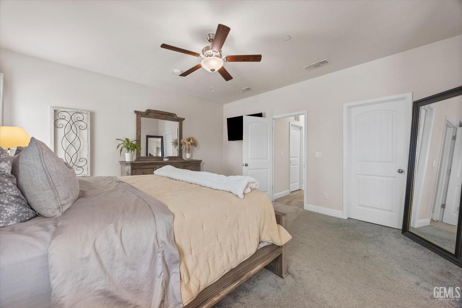 Undisclosed Address Shafter, CA 93263 - Photo 24 of 43 a bedroom with a large bed and a chandelier