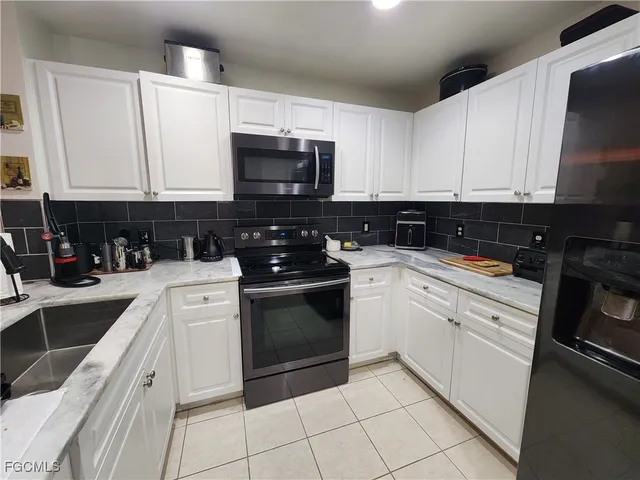 a kitchen with stainless steel appliances granite countertop a sink and a stove