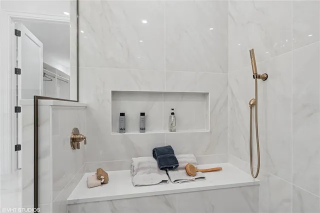 a spacious bedroom with a bed and a chandelier