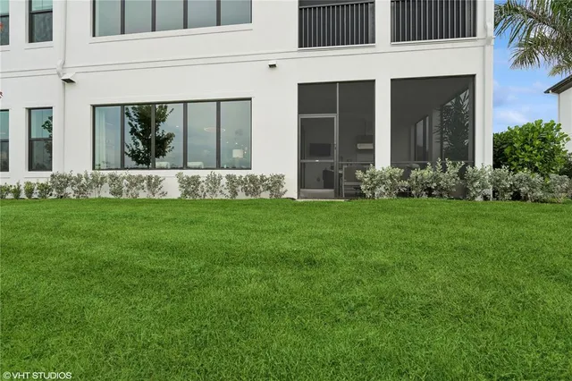a view of a house with a yard and sitting area