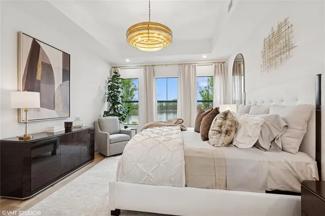 a bedroom with a bed a mirror and a dresser