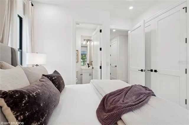 a bedroom with a bed and a lamp