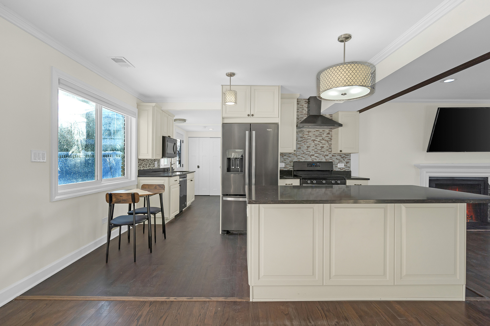 3225 Illinois Road Wilmette, IL 60091 - Photo 13 of 22 a kitchen with stainless steel appliances granite countertop a stove a refrigerator a oven a sink a dining table and chairs with wooden floor