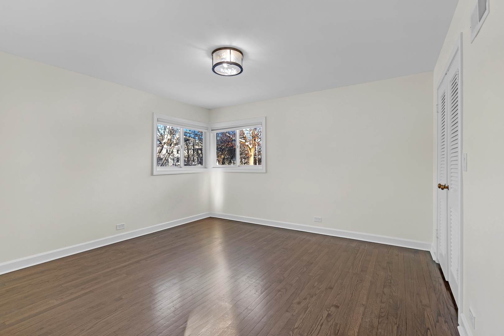 3225 Illinois Road Wilmette, IL 60091 - Photo 14 of 22 an empty room with wooden floor and windows