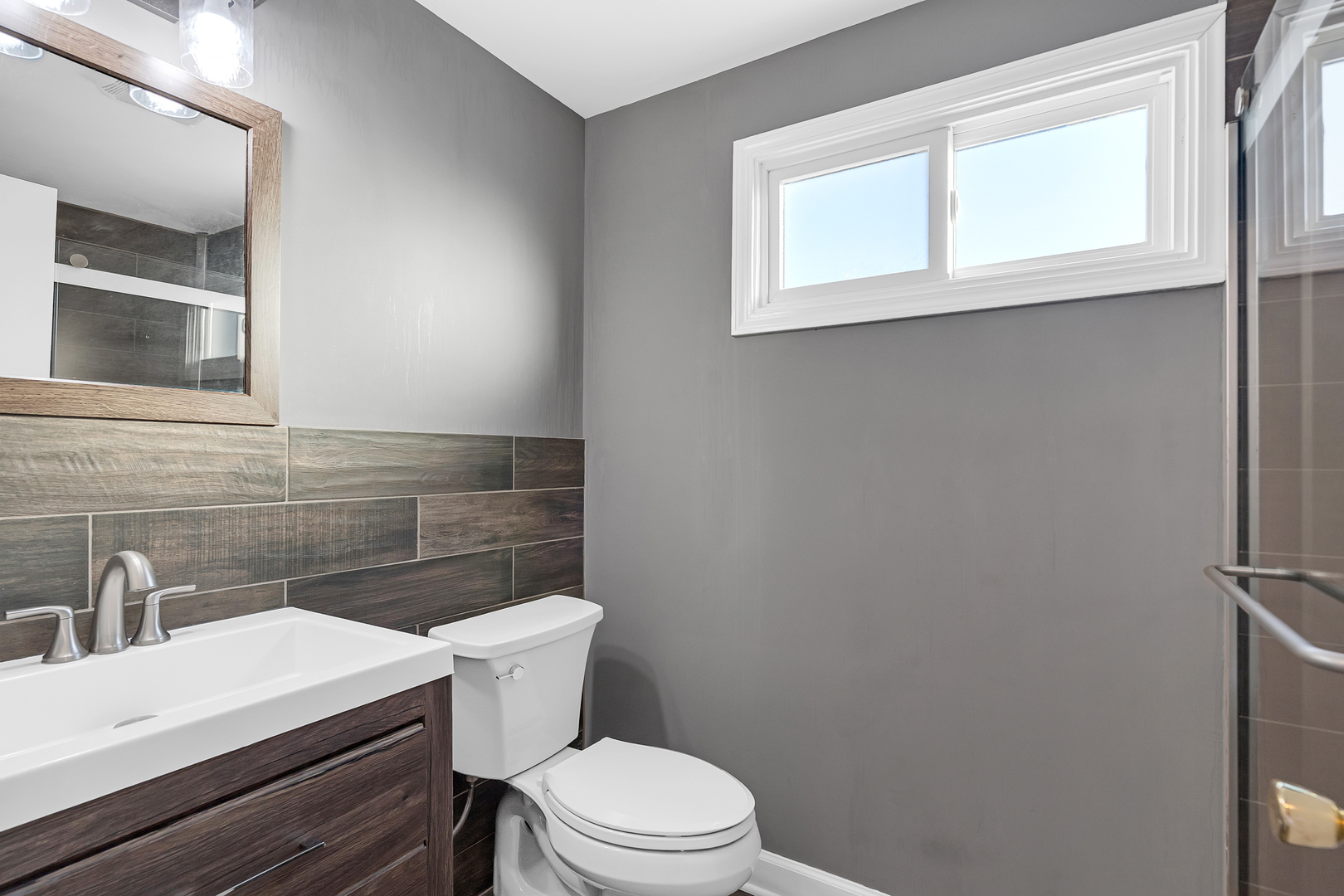 3225 Illinois Road Wilmette, IL 60091 - Photo 18 of 22 a bathroom with a sink a toilet and mirror