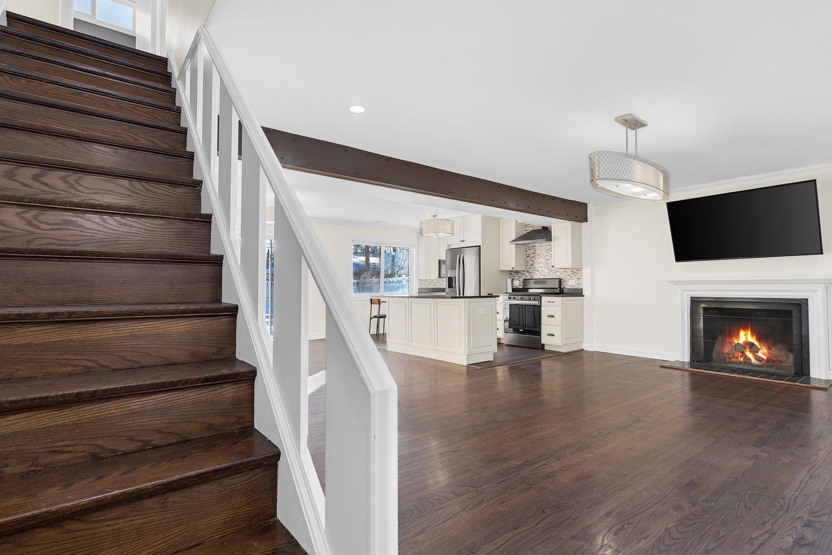 3225 Illinois Road Wilmette, IL 60091 - Photo 2 of 22 a view of an empty room with wooden floor fireplace and a window