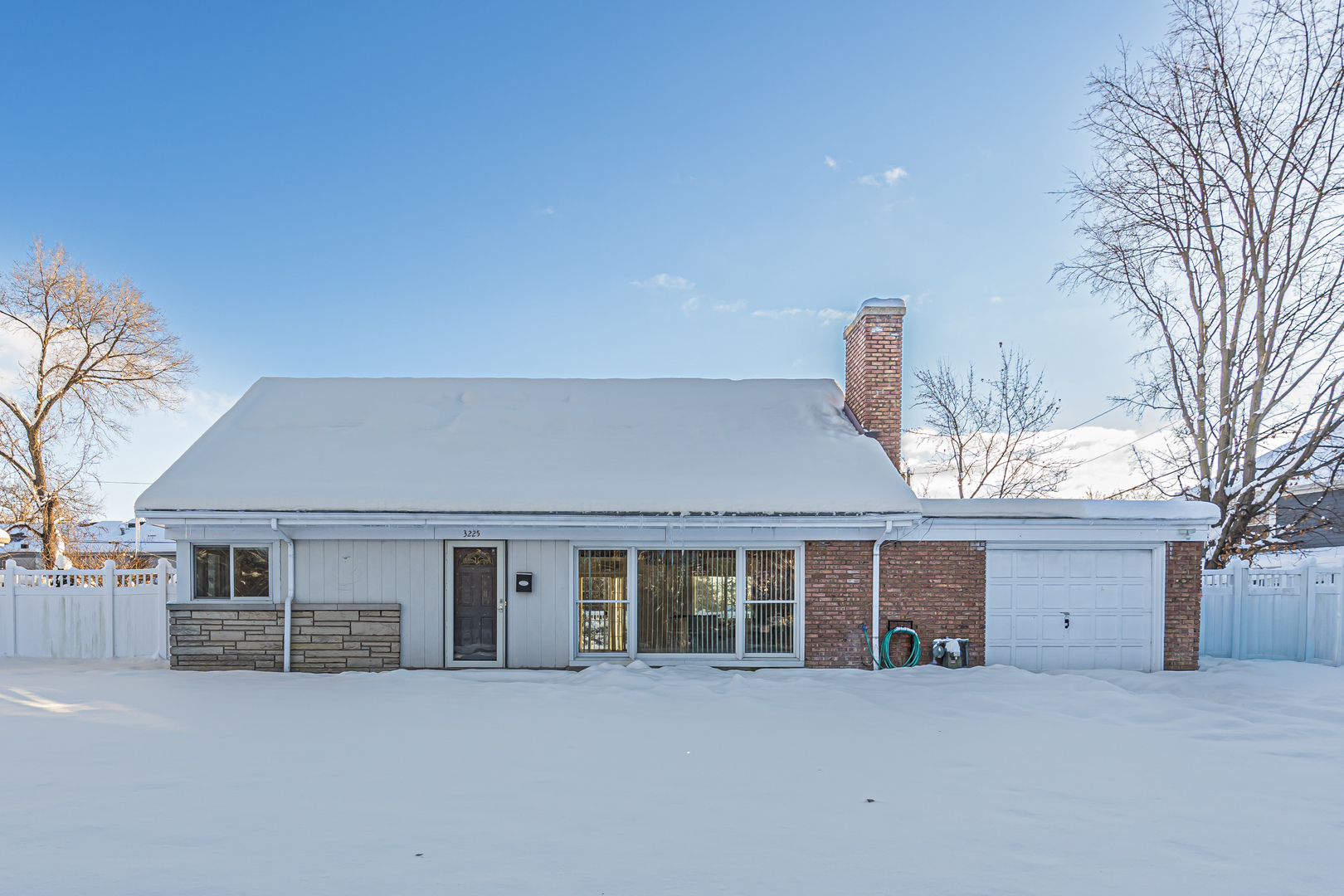 3225 Illinois Road Wilmette, IL 60091 - Photo 3 of 22 a front view of a house with a yard and garage
