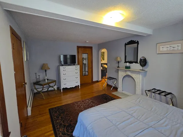 a bedroom with a bed and wooden floor