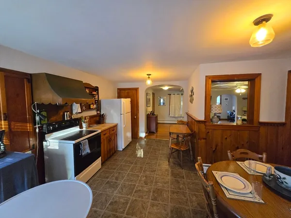 a room with furniture a large window and wooden floor