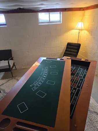 a view of a house with a big yard and large trees