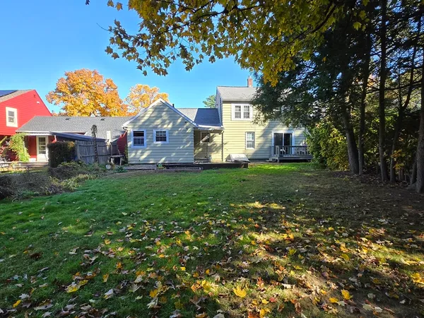a view of house with backyard and sitting area