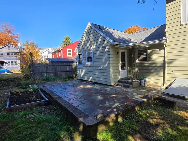a view of a yard with plants and trees
