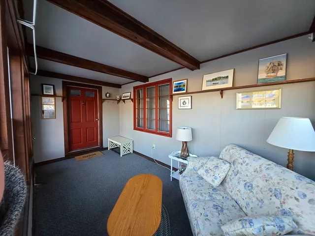 a bedroom with bed and wooden floor