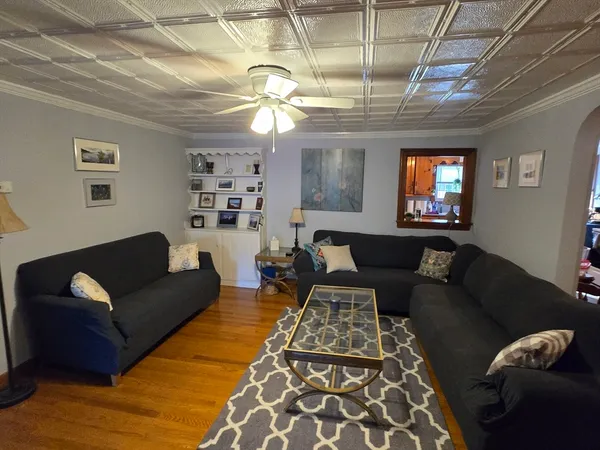 a living room with furniture and a chandelier