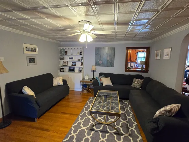 a living room with furniture and a chandelier